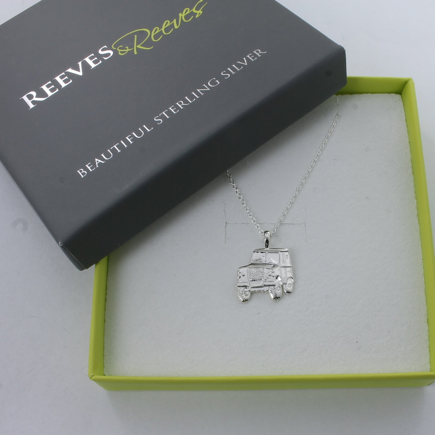 A sterling silver Landrover necklace, 2dimensional in style and hung on a silver chain, shown in a Reeves & Reeves box.