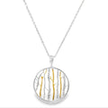 Sterling Silver necklace with a round pendant featuring gold plate and silver birch tree designs. hanging on an adjustable silver chain.