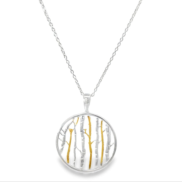 Sterling Silver necklace with a round pendant featuring gold plate and silver birch tree designs. hanging on an adjustable silver chain.