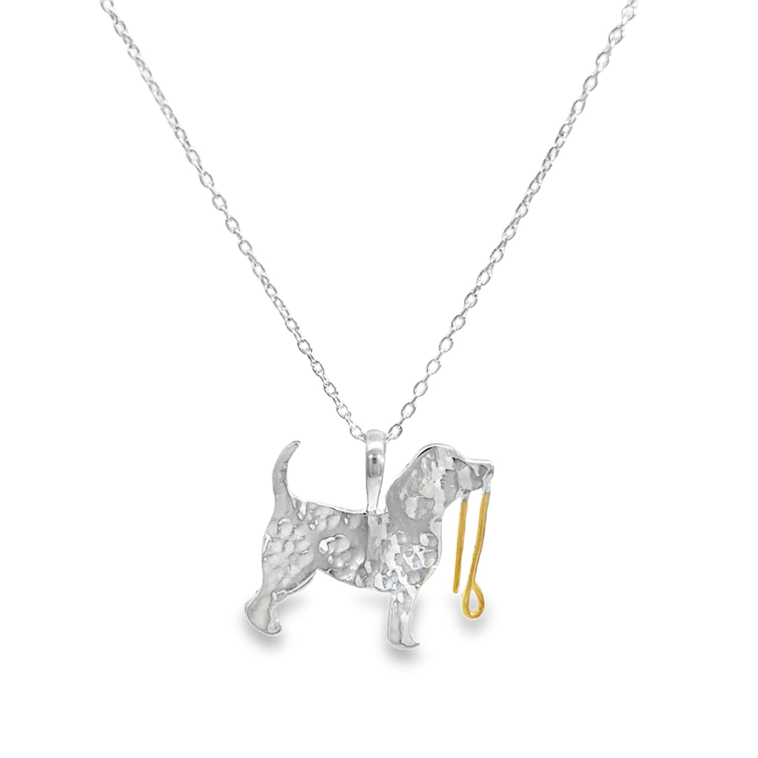 Silver dog pendant with a hammered finish, holding a gold plate lead in its mouth. The pendant hangs on a silver adjustable chain.