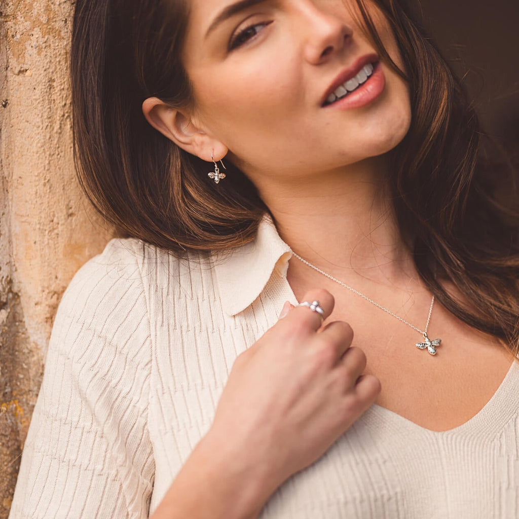 A pair of Sterling Silver Bumble Bee drop earrings, worn on a lady with the matching necklace.