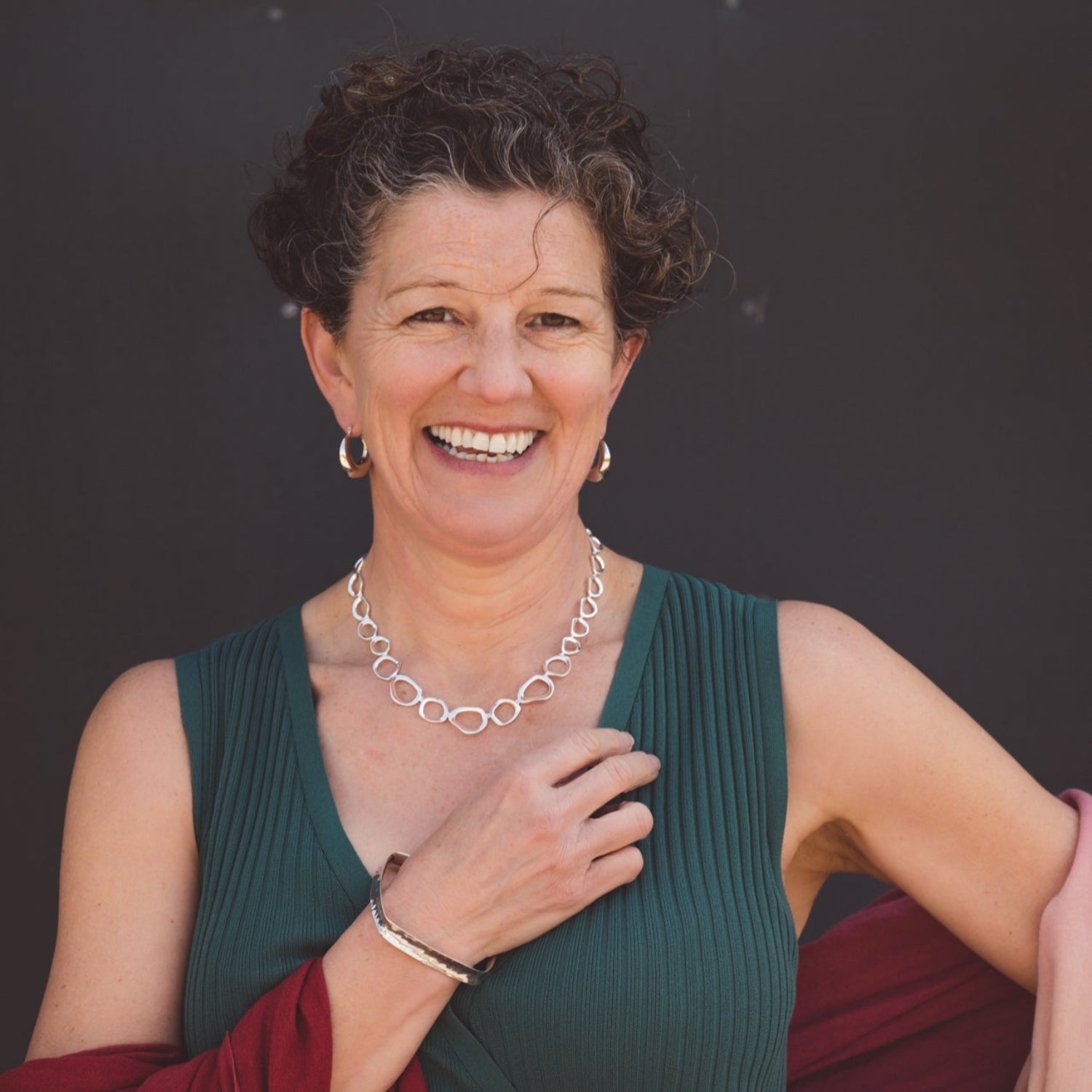 A sterling silver ringlets necklace, comprising of rings with undulated edges in a continuous line to create this statement necklace. Worn on a models neck.