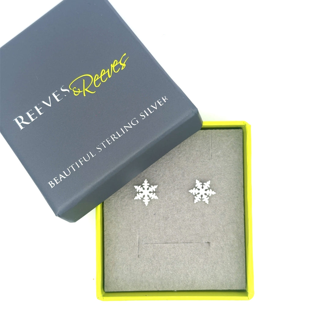 Sterling Silver Snowflake Stud Earrings shown in a grey and green Reeves & Reeves gift box.
