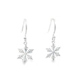 A pair of silver dangle earrings featuring detailed snowflake charms, shown against a plain white background.
