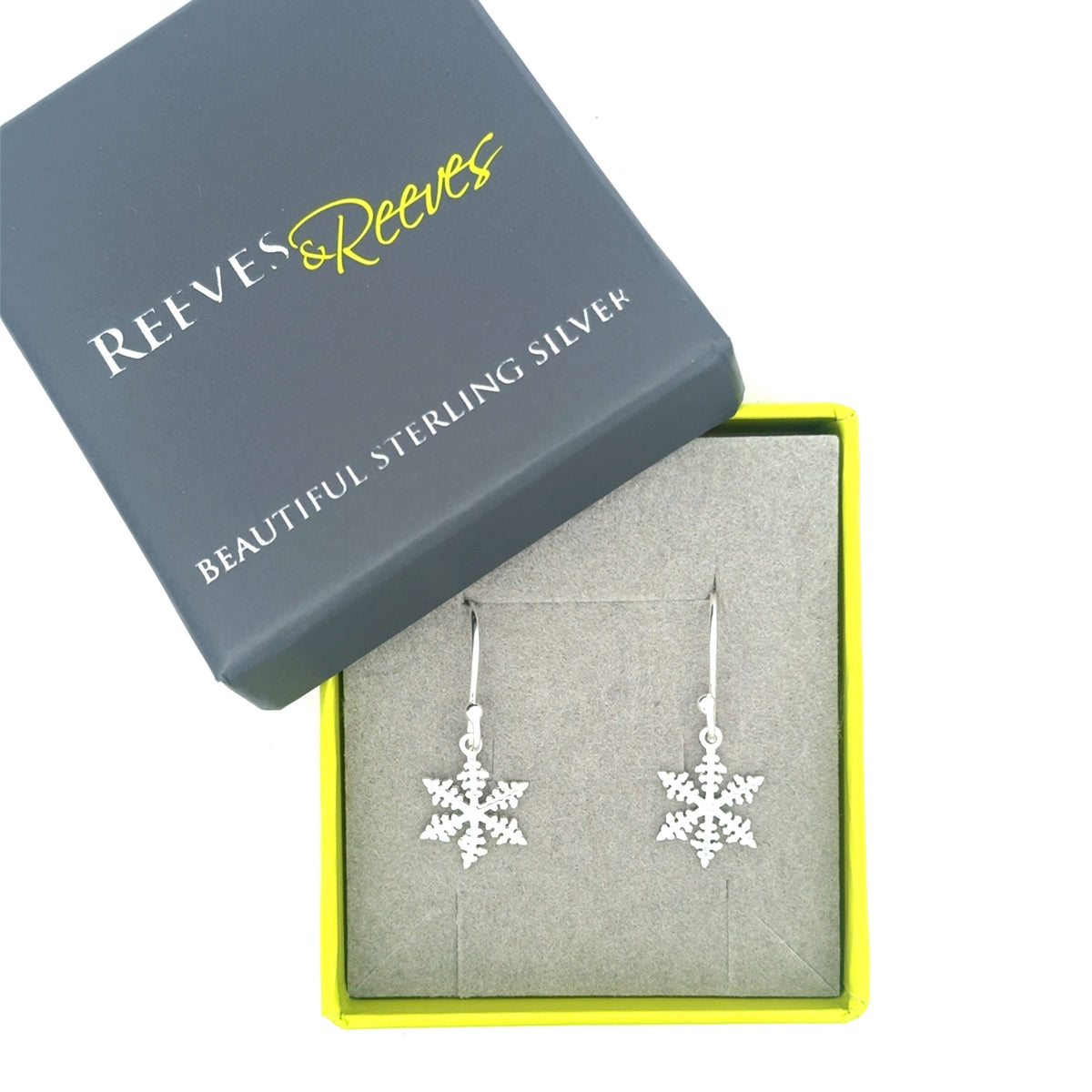 Sterling Silver Snowflake Earrings on a silver hook and shown in a Reeves & Reeves grey and green gift box.