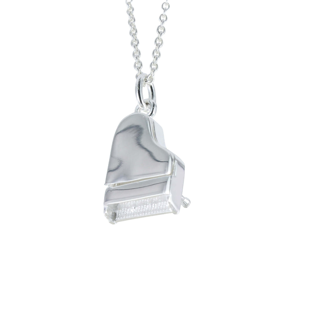 A sterling silver piano pendant where the lid opens, hung on a silver adjustable chain.