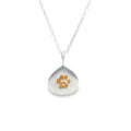 Teardrop-shaped  silver pendant with a gold plated paw print design in the centre. The pendant hangs on an adjustable chain.