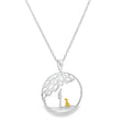 A sterling silver circular necklace with a tree design inside, and a silhouette of a person with an 18ct gold plated dog sat beneath the tree. The pendant hangs on a silver adjustable chain.