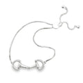 Silver bracelet with horsebit design on a white background