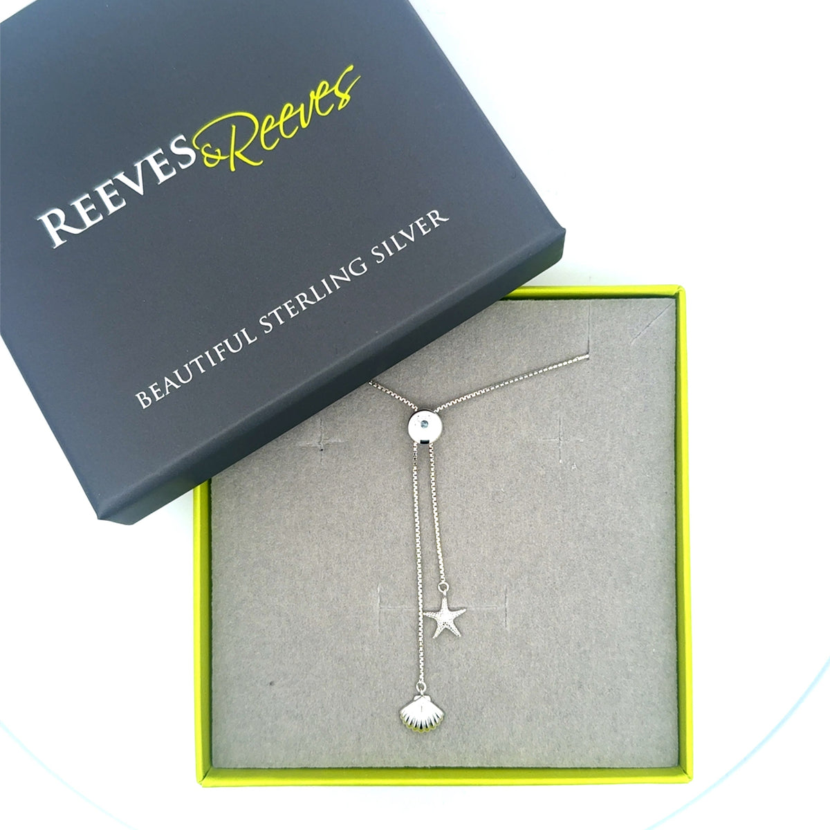 Seashell slider necklace in a Reeves & Reeves gey and green gift box.