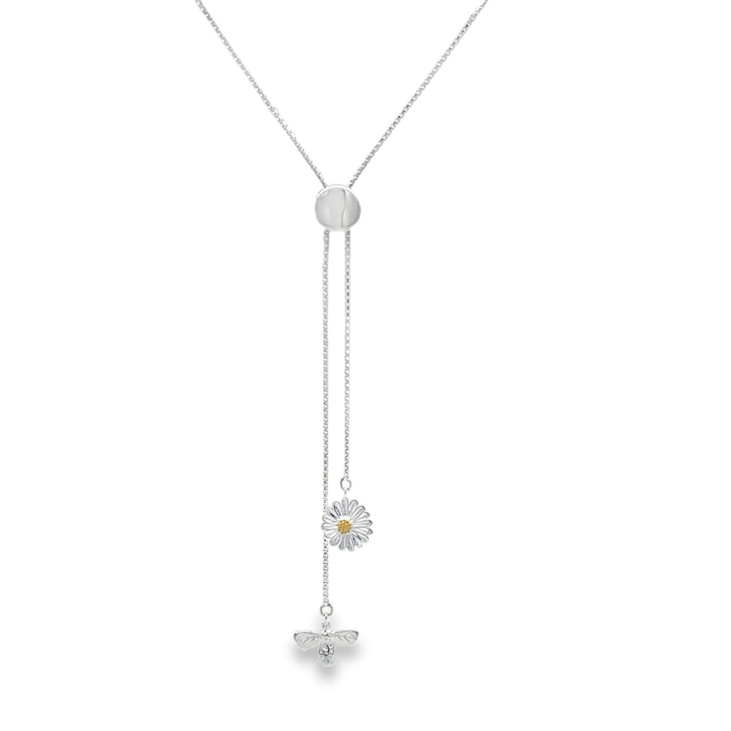A slider necklace with a daisy and bee charm hanging from the fine chains.
