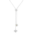 A slider necklace with a daisy and bee charm hanging from the fine chains.