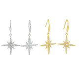 eight point star-shaped earrings in silver and gold plate, with cubic zirconia stones hanging on silver hooks.