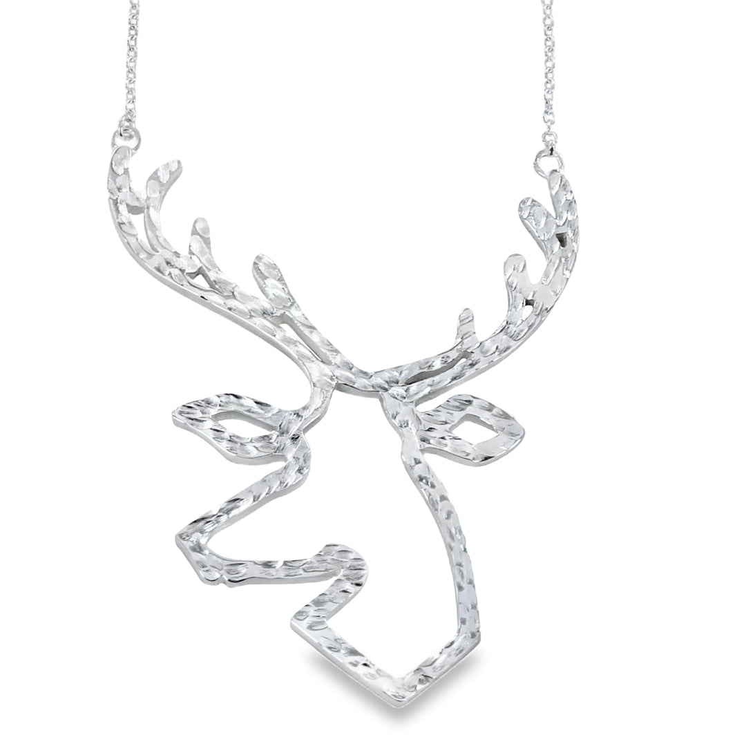A silver Stag head pendant necklace with a textured, hammered finish, suspended from a delicate silver chain against a plain white background.