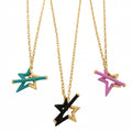 Three sterling silver star gold plated star necklaces hanging on gold chains. Each necklace has a star as the central feature, half coated in coloured enamel. Choose from turquoise, black or pink. The stars have matching enamel T bars through the centre as the clasp.