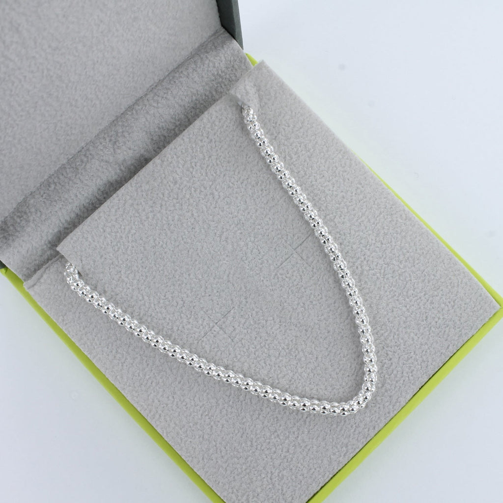 Silver Bobble Necklace shown in a Reeves & Reeves grey and green branded gift box.