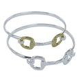 Two sterling silver cuff bracelets, featuring a snaffle as the central design,  one with gold vermeil accents. The snaffle also doubles as the clasp.