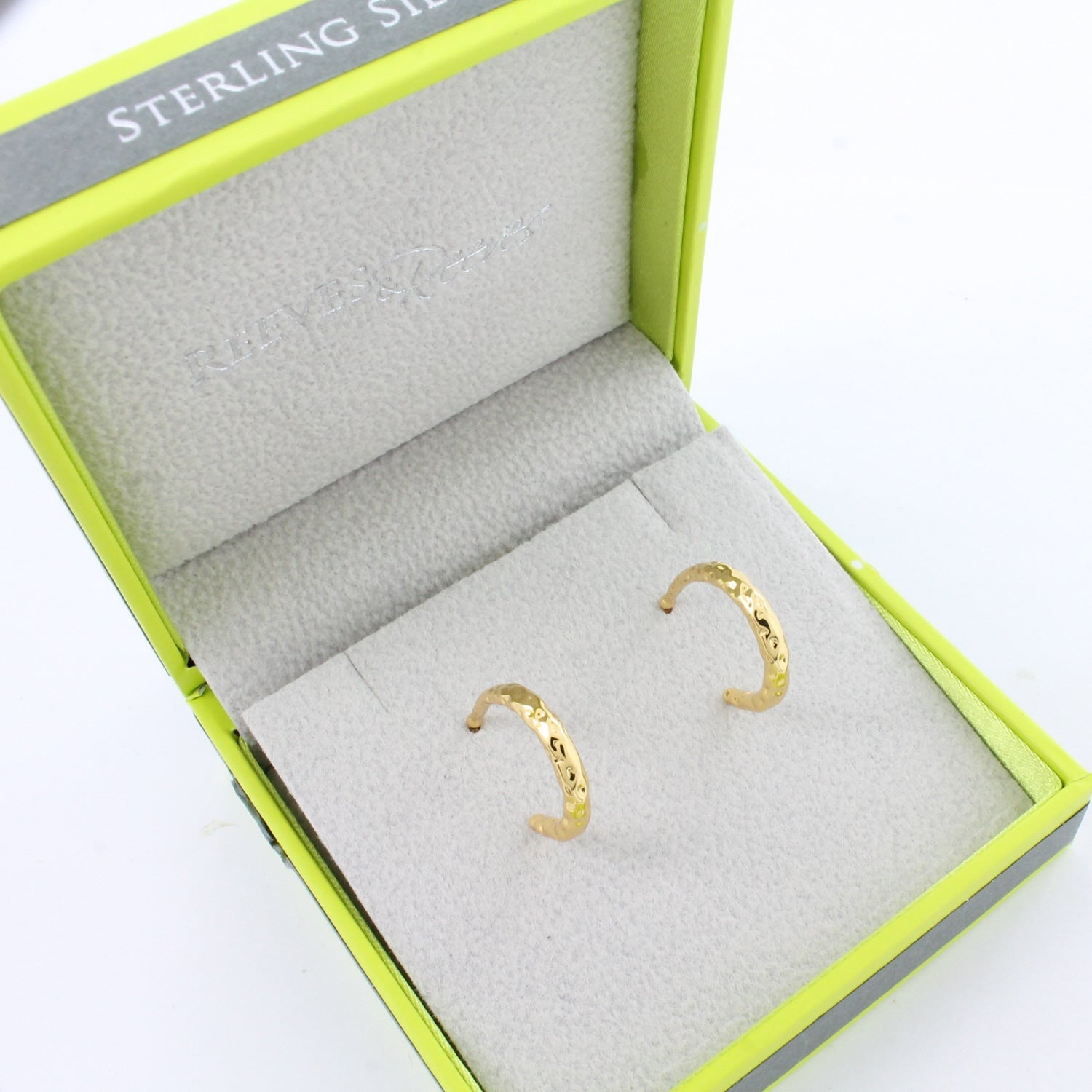 Gold plated textured hoop earrings in a Reeves & Reeves grey and green branded gift box.