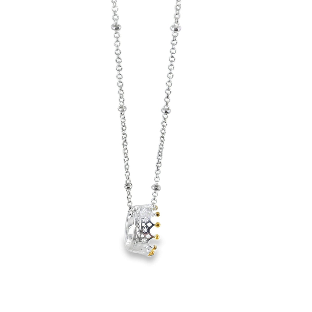 Sterling Silver Crown Pendant with gold plated detail on the crown spikes, hanging on a silver beaded chain.