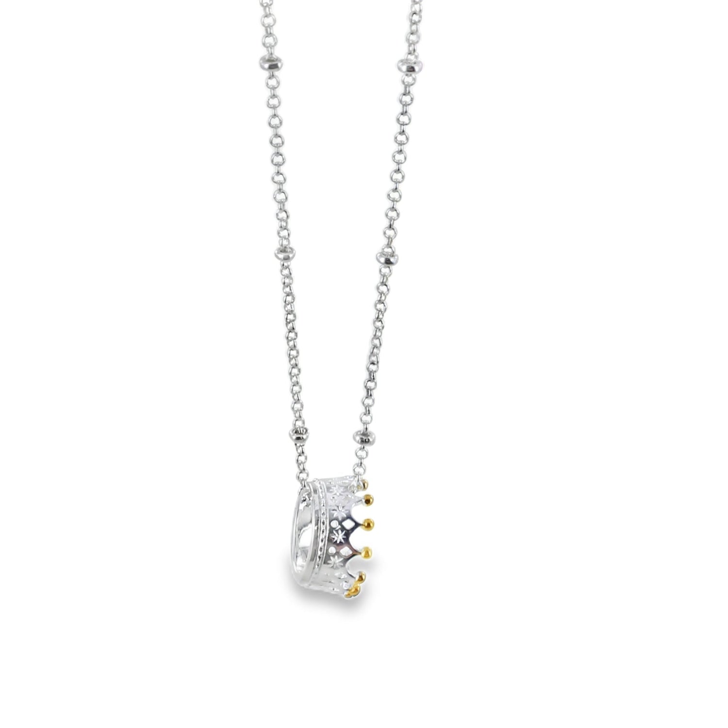 Sterling Silver Crown Pendant with gold plated detail on the crown spikes, hanging on a silver beaded chain.