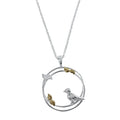 A sterling silver circular pendant with a two-ring design featuring birds perched on the edges and leaves with gold plated detail. Hung on a silver adjustable chain.