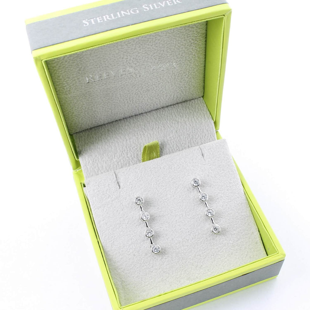 A pair of sterling silver drop earrings, with cubic zirconia stones set in a vertical line. Shown in a Reeves & Reeves gift box.