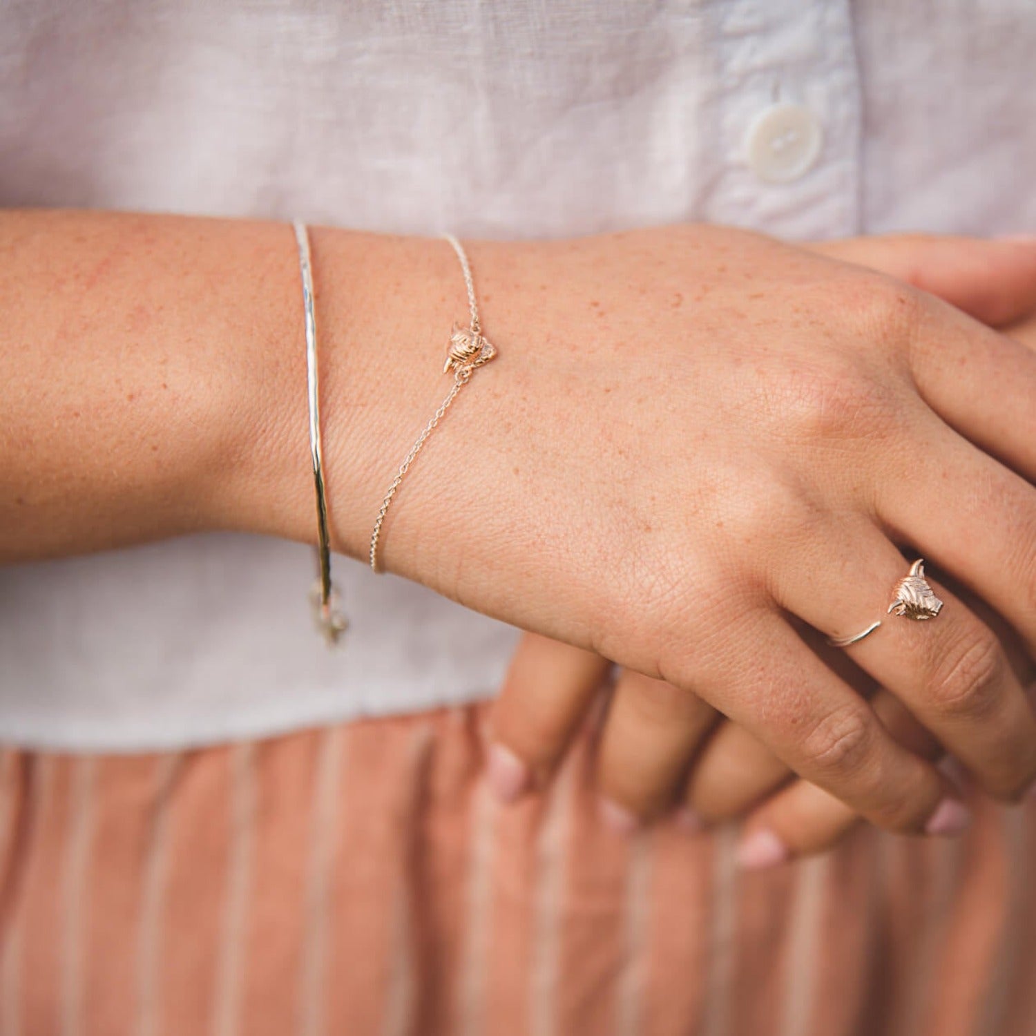 A Silver and rose gold plated Highland Cow Bracelet, paired with a bangle and a matching highland cow ring.