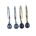 Two pairs of long loop drop earrings, one silver and one gold plated, both with dark peacock coloured freshwater pearls hanging from the bottom.