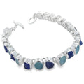 Rough cut aqua marine and tanzanite stones, set in sterling silver in a continuous design and finished with a t bar and a circular clasp.