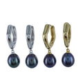 Two pairs of pentagon shaped huggie earrings, one silver and one gold plated with peacock pearl charms hanging from the bottom.