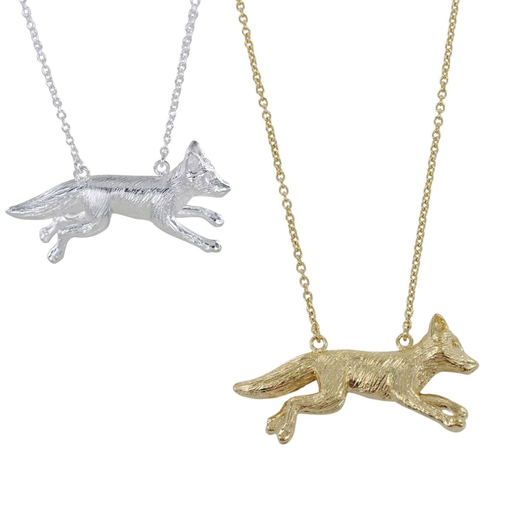 Gold and silver fox pendants on chains against a white background