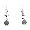 A semi precious labradorite stone in a pear shape sits at the bottom of a silver chain and hangs on silver hooks with coloured stones set down the chain.