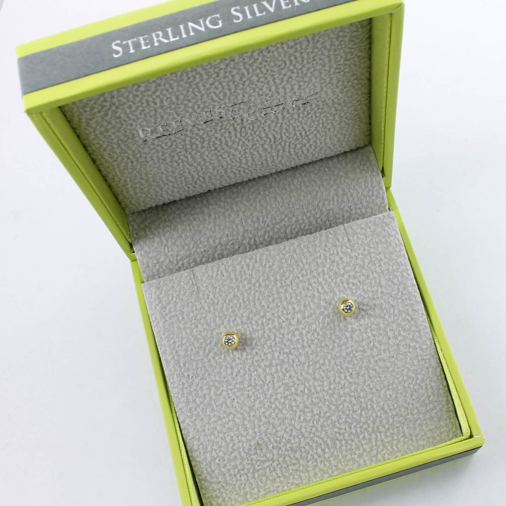 A pair of sparkling bead stud earrings in 18ct gold plate, with a cubic zirconia stone in the middle, shown in a Reeves & Reeves gift box.