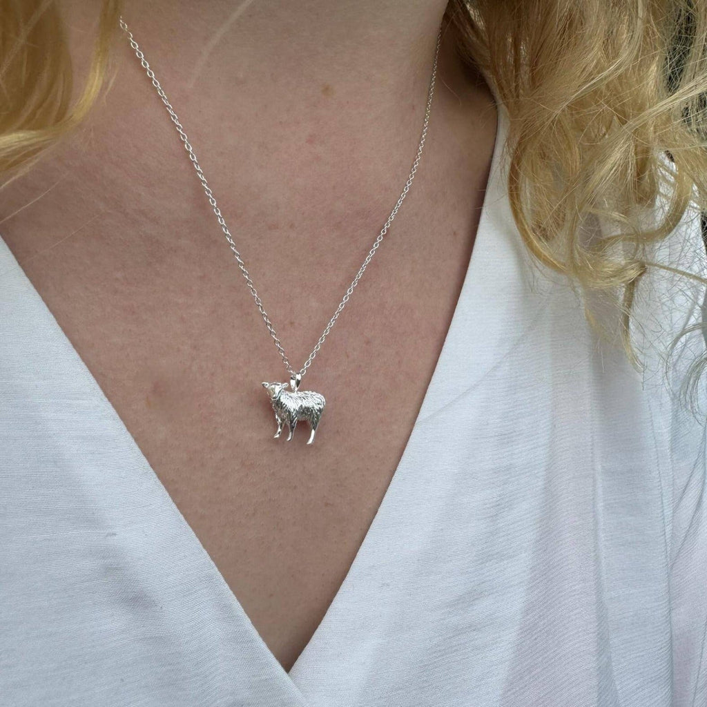 Sterling Silver Sheep Pendant, hanging on a silver adjustable chain and worn on a model.