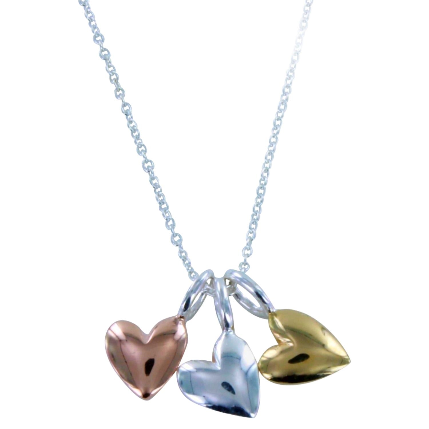 Necklace with three heart-shaped pendants in silver, rose gold, and yellow gold, hanging together on a silver chain.