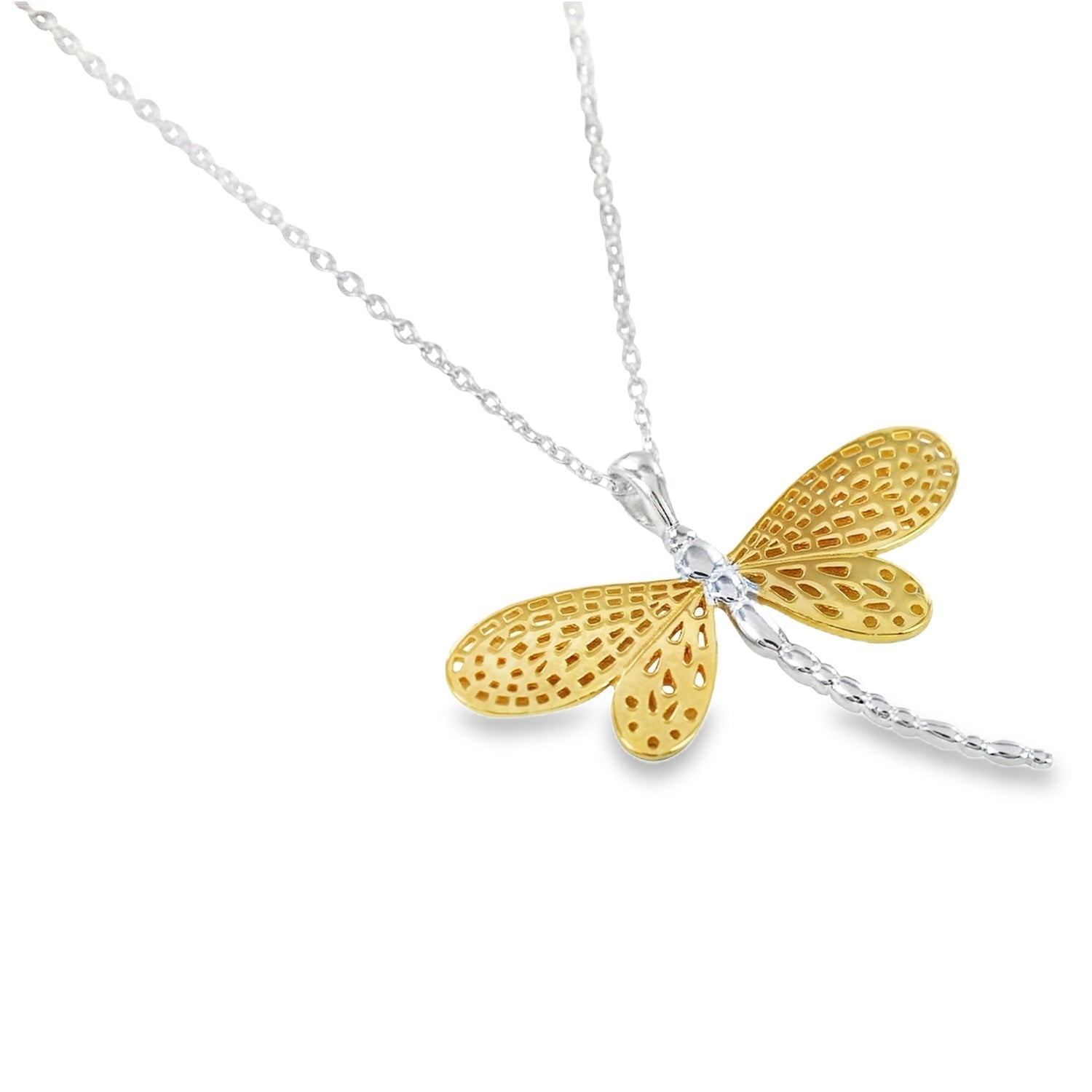 Gold and silver dragonfly pendant with cut outs in its wings, hanging on a silver adjustable chain.