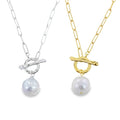 Two silver and gold plate paperclip chain necklaces with a circle central feature which doubles as the clasp with a T Bar going through it. A white freshwater pearl hangs from each necklace.