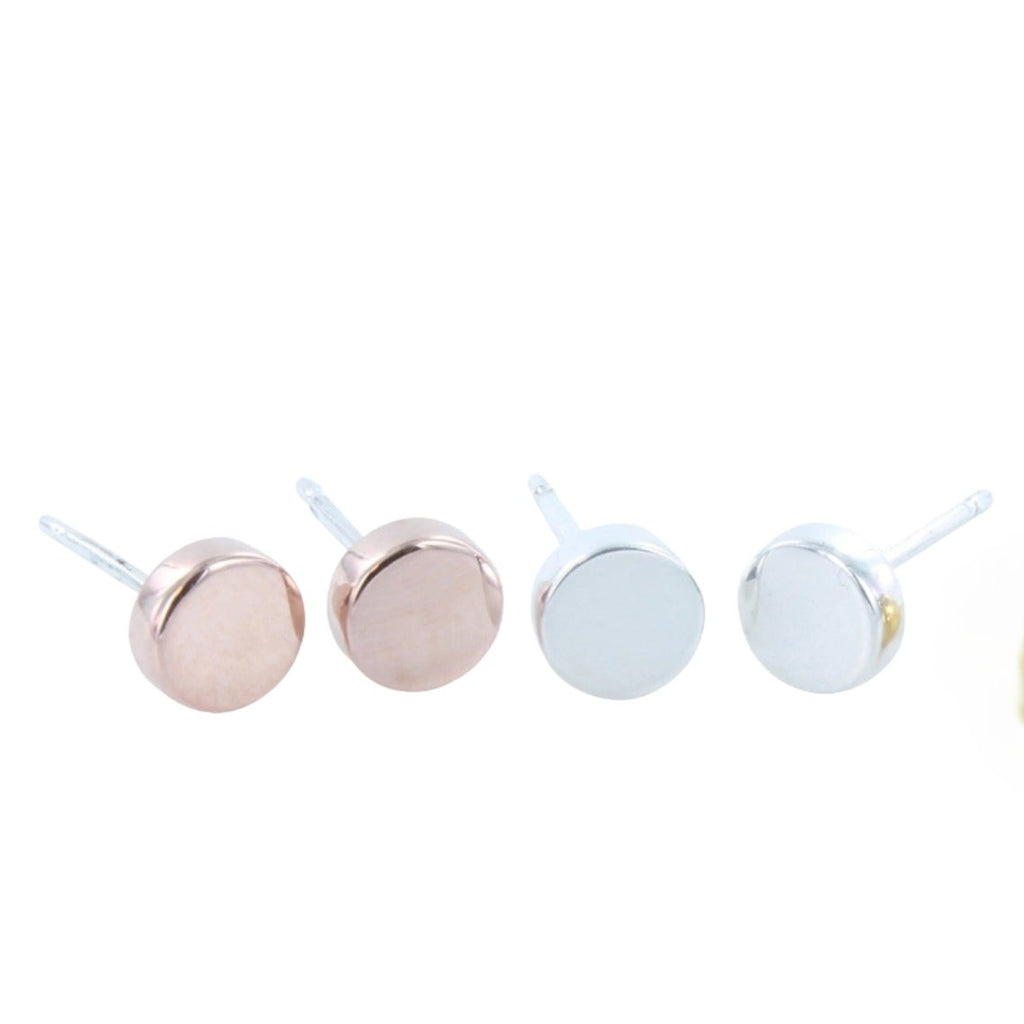 Two pairs of round high shine stud earrings, one in silver and one in rose gold plate.