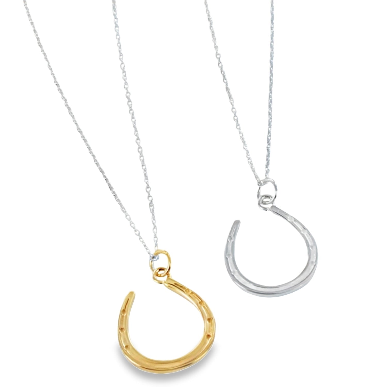 Two fine horseshoe necklaces, one in sterling silver and one in gold plate finish, both hanging on silver adjustable chains.