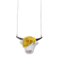 A super size highland cow face, in sterling silver with a rose gold plated nose, yellow gold plated hair and black ruthenium horns. The cow hangs centrally on a silver fine chain.
