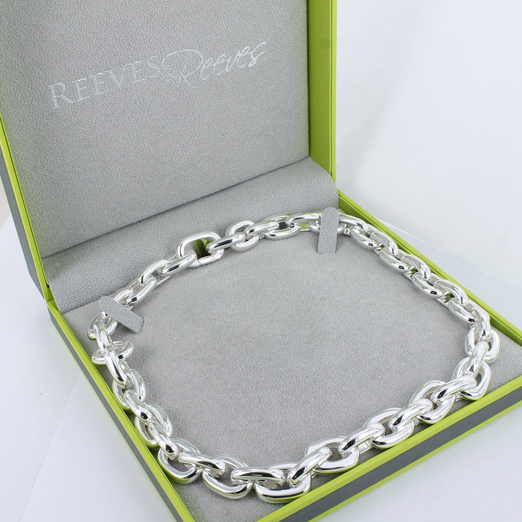 A sterling silver super size paperclip style chain necklace, shown in a Reeves & Reeves grey and green gift box.