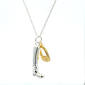 A sterling silver riding boot charm with a gold plated stirrup charm hanging side by side, both hung on a silver adjustable chain.