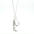 A sterling silver boot and stirrup charm hanging from a silver adjustable chain.