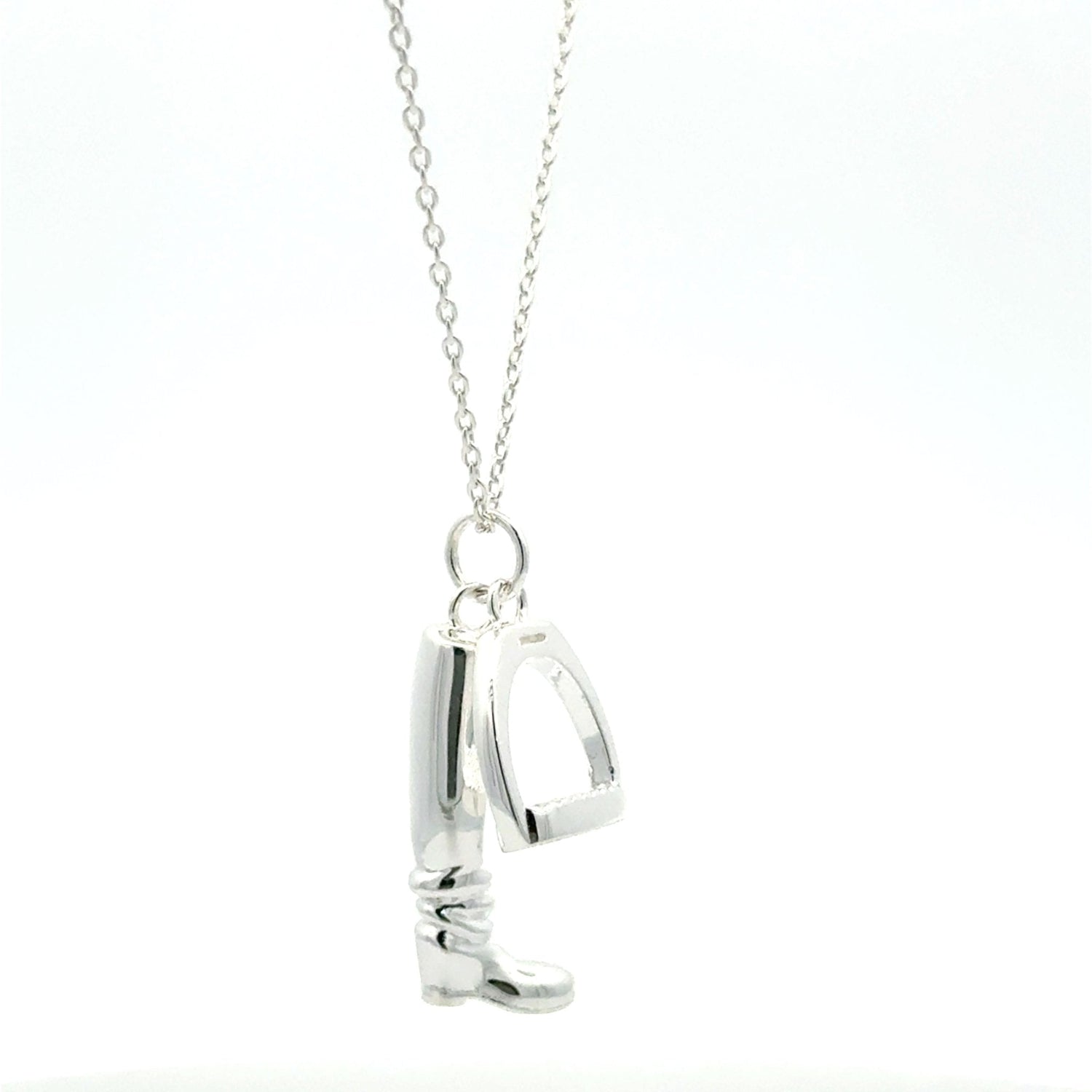 A sterling silver boot and stirrup charm hanging from a silver adjustable chain.