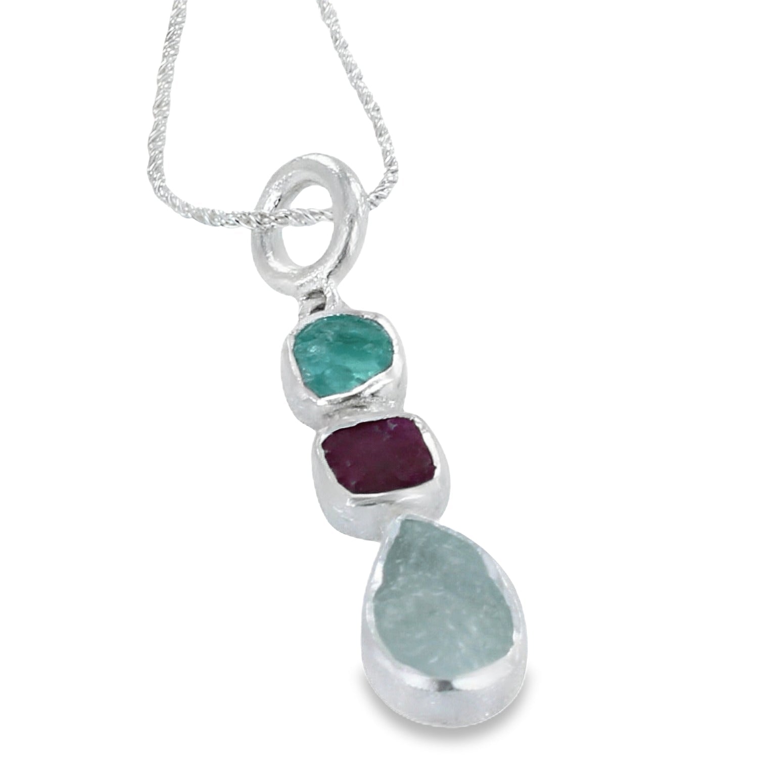 Sterling silver pendant with three rough stones, one aqua, one ruby and one apatite in a vertical design, hung on a rope style chain.