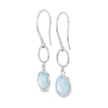 A pair of sterling silver drop earrings with textured circles hanging from silver hooks. Below the circles hangs an aqua chalcedony stone.