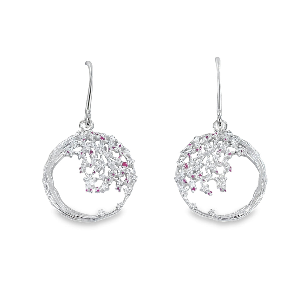 A pair of sterling silver drop earrings which feature a circular design and a cherry blossom design hanging from inside the circle. The design hangs from silver hooks.