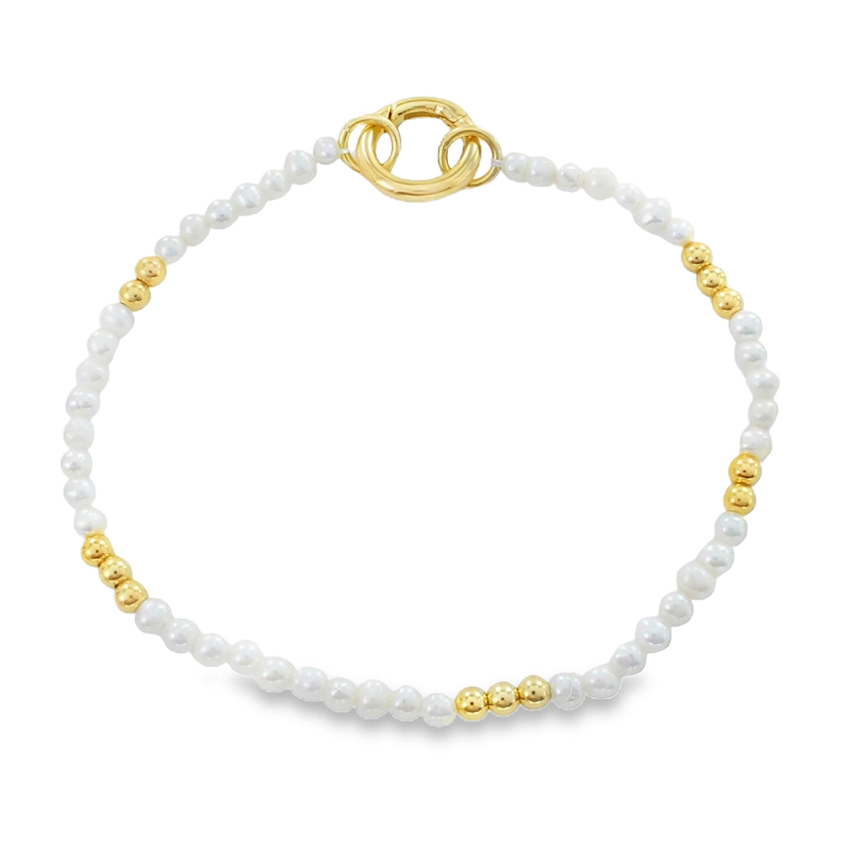 A pearl bracelet with white pearls, interspersed with 18ct gold plated pearls around the bracelet. The chain is finished with a circular clasp which also doubles as the central feature.