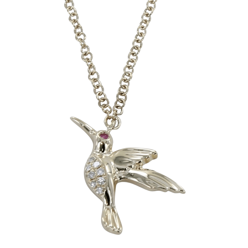 A 14k solid gold humming bird pendant with diamonds on its tummy and a ruby in its eye. Hung on a solid gold chain.