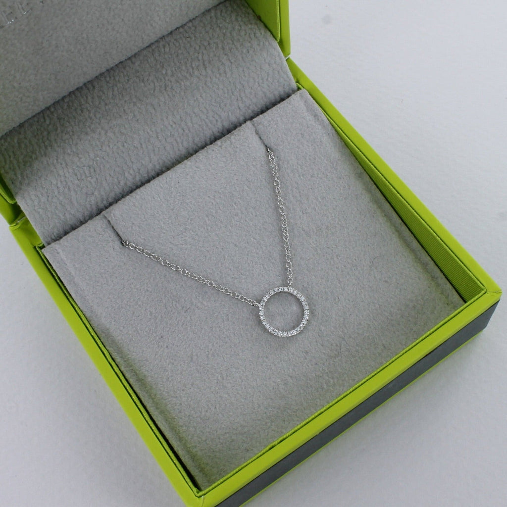 A solid 14k white gold ring necklace, encrusted with diamonds and shown in a Reeves & Reeves gift box.